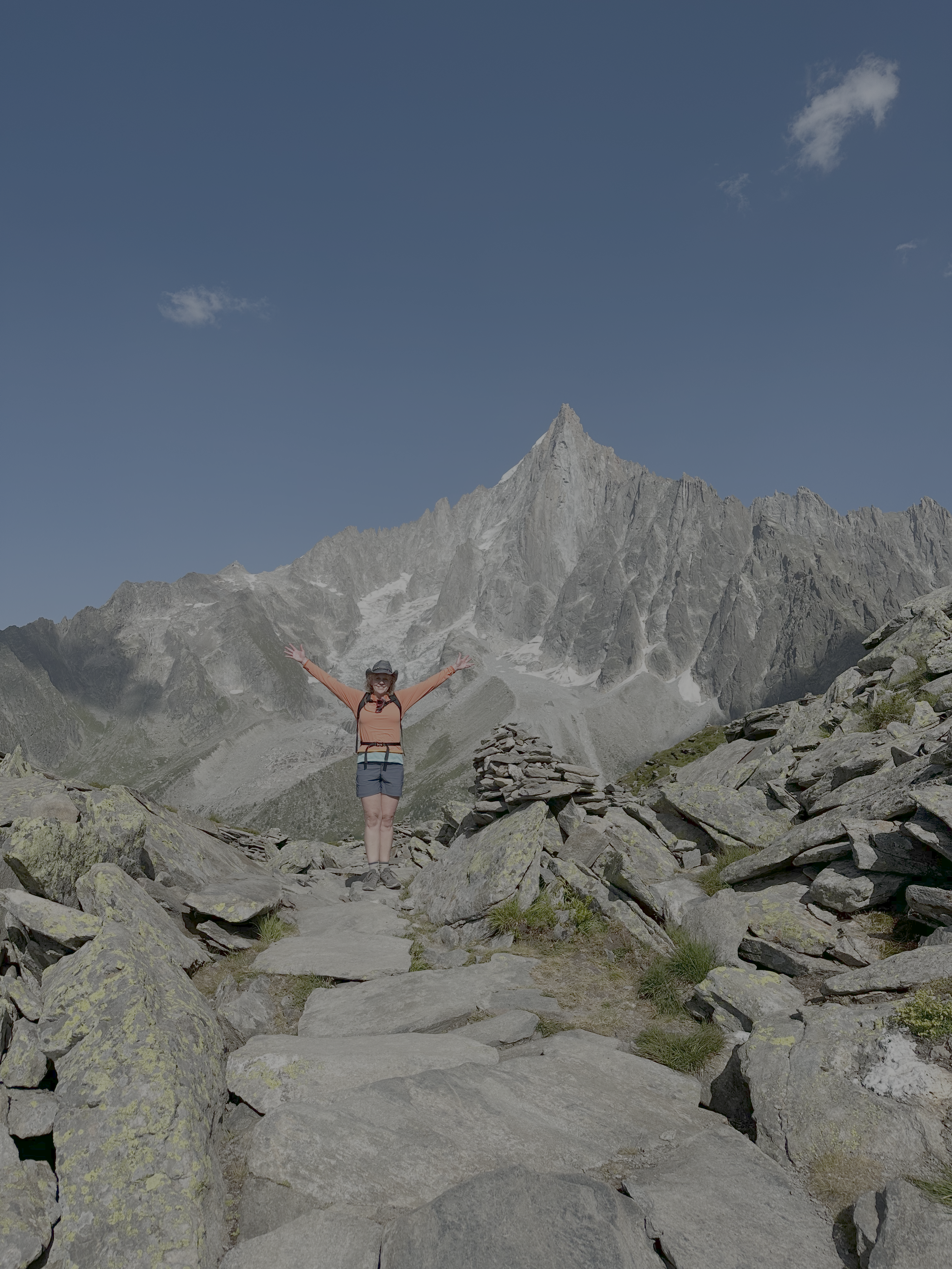 Sara hiking near a cairn in the mountains